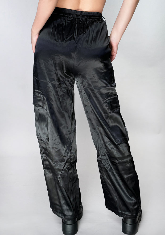 Hot & Delicious Night Beat Black Satin Cargo Pants in black — model back view