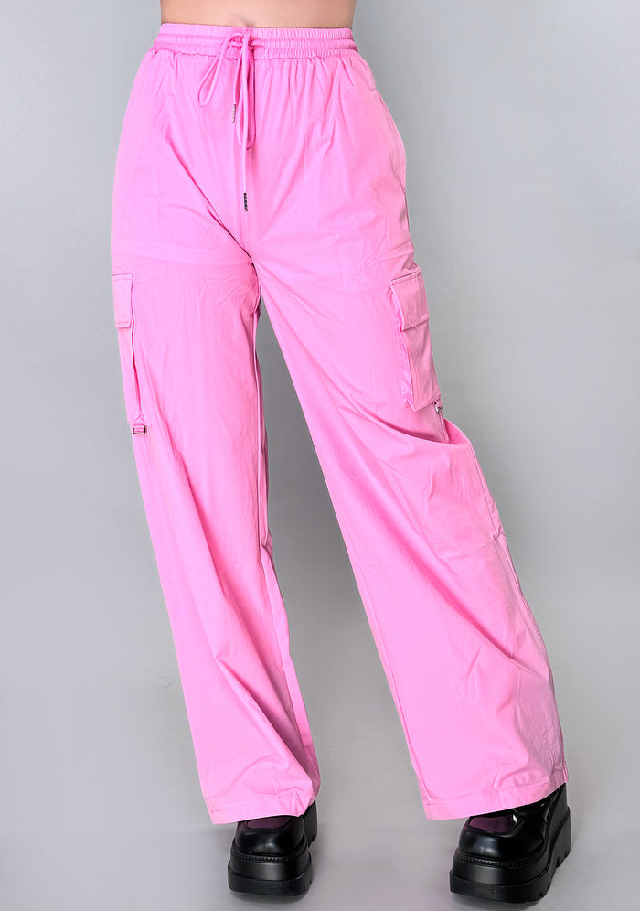 Hot & Delicious Beat Babe Pink Cargo Pants in pink with dual cargo pockets and drawstring tie on urban rave bottoms — model view