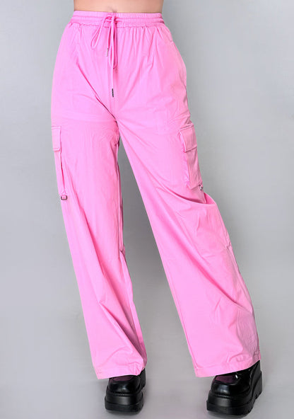 Hot & Delicious Beat Babe Pink Cargo Pants in pink with dual cargo pockets and drawstring tie on urban rave bottoms — model view