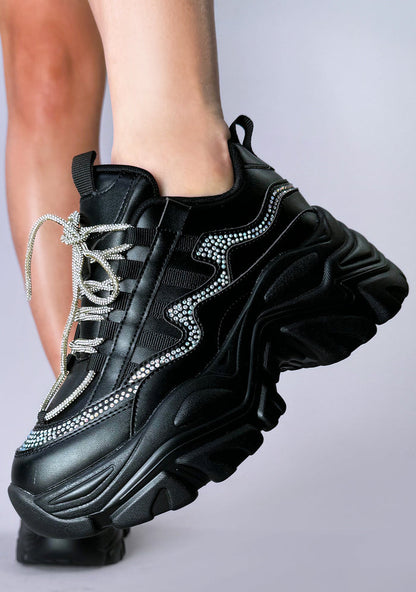 Side angle on-foot shot of the Berness BILLIE Darkwave rhinestone black platform sneakers, highlighting the 2-inch platform height, flexible low-top fit, and reflective rhinestone details along the side panels.