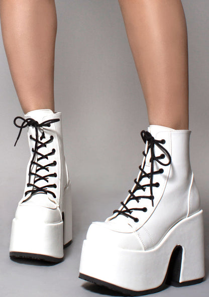 Demonia CAMEL 203 Deja Vu White Platform Boots in white vegan patent leather with 5 inch chunky platform heel and back metal zip worn by model — front view