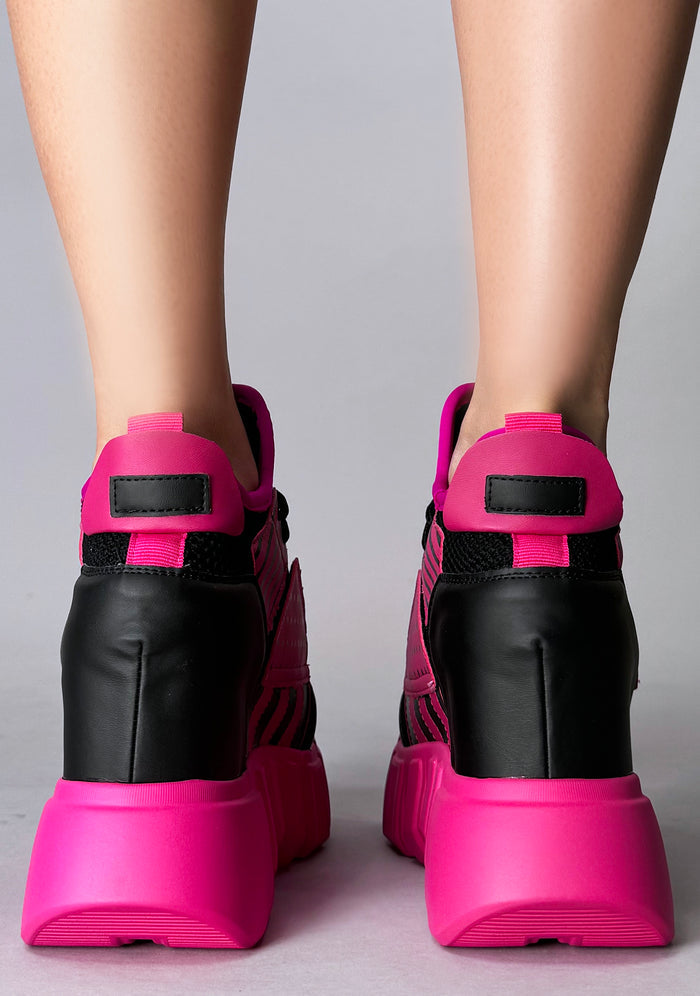 Rear studio shot from behind of Anthony Wang CRANBERRY 08 Pink Circuit platform sneakers detailing the supportive black heel structure, neon pull tabs, and robust tread traction
