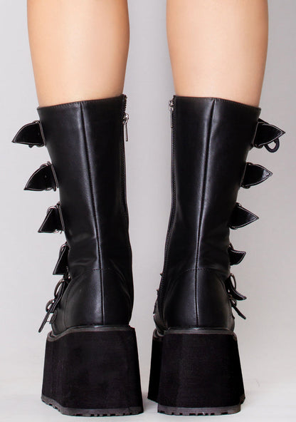 Demonia DAMNED 225 Dark Soul Black Platform Boots in black vegan leather with inside metal zip closure worn by model — back view