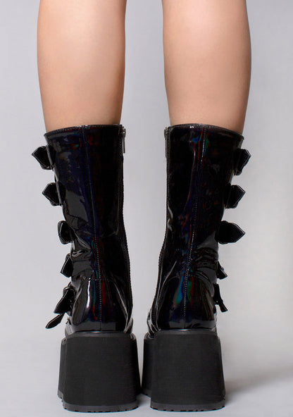 Demonia DAMNED 225 Necromancer Hologram Black Platform Boots in iridescent holographic vegan leather with cone stud hardware worn by model — back view
