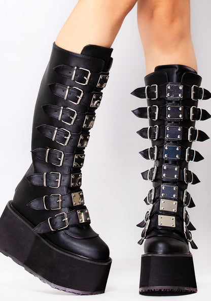 Demonia DAMNED 318 Obsession Black Platform Boots in black vegan leather with 8 cone studded buckle straps and chrome hardware worn by model — front view