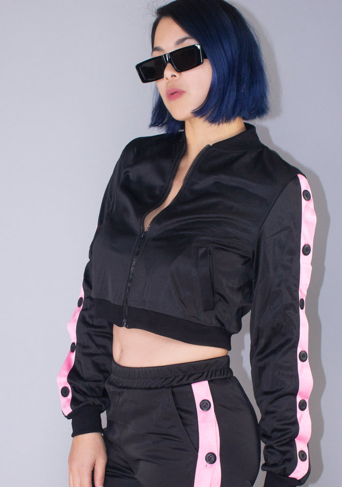 Hot & Delicious Deal With It Tracksuit Crop Jacket in black pink with contrast stripe and button detail on rave jacket — model view