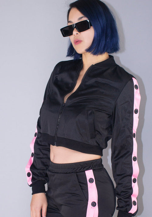 Hot & Delicious Deal With It Tracksuit Crop Jacket in black pink with contrast stripe and button detail on rave jacket — model view