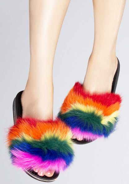 Front view of the multicolored Fever Dream faux fur sandals on-model, showcasing the fluffy rainbow strap and shimmering rhinestone edge details.
