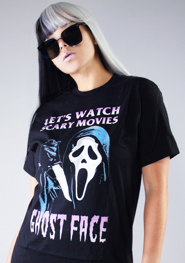 Bioworld Ghostface Let's Watch Scary Movies Unisex Tee in black with Ghostface front graphic on horror fandom rave festival top — model view