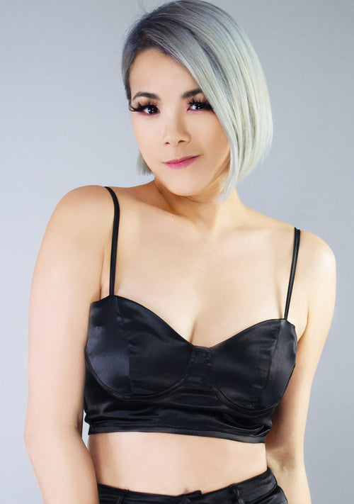 Hot & Delicious Glamour Fest Satin Bustier Crop Top in black with silky satin finish and metal zipper closure on festival top — model view