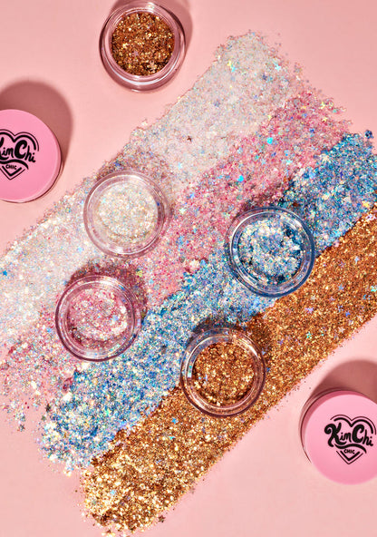 Kimchi Chic GLITTER SHARTS Gel Glitter Pots in 01 Super Galactic blue with holographic star and hexagon glitter in gel pot on rave makeup body glitter — model body view