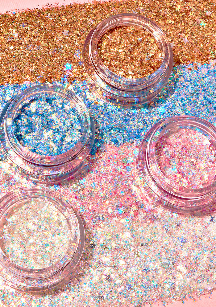 Kimchi Chic GLITTER SHARTS Gel Glitter Pots in 04 Super Star gold with holographic star and hexagon glitter in gel pot on rave makeup body glitter — model cheek view