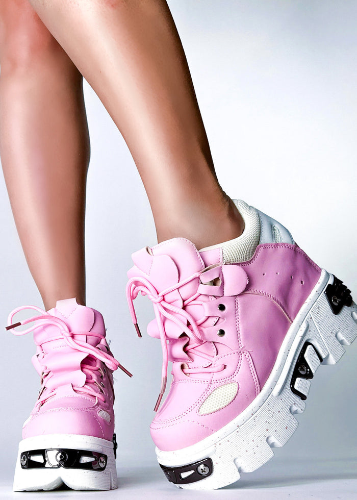 On-foot styling view of Anthony Wang GUAVA 02 Momo Love Pink platform sneakers showcasing the low-top fit, black structural heel cages, and hidden interior wedge heel lift