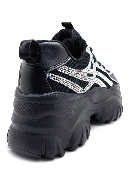 Rear view of the black Berness platform sneakers, detailing the high-profile chunky rubber heel and wavy white accent lines on the sole.