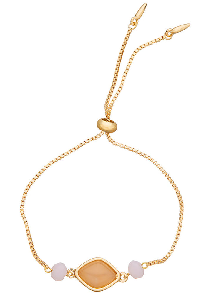Charged Heart Rose Quartz Gemstone Bracelet in gold with raw rose quartz centerpiece and glass bead accents on adjustable 18k gold plated crystal festival bracelet — front view