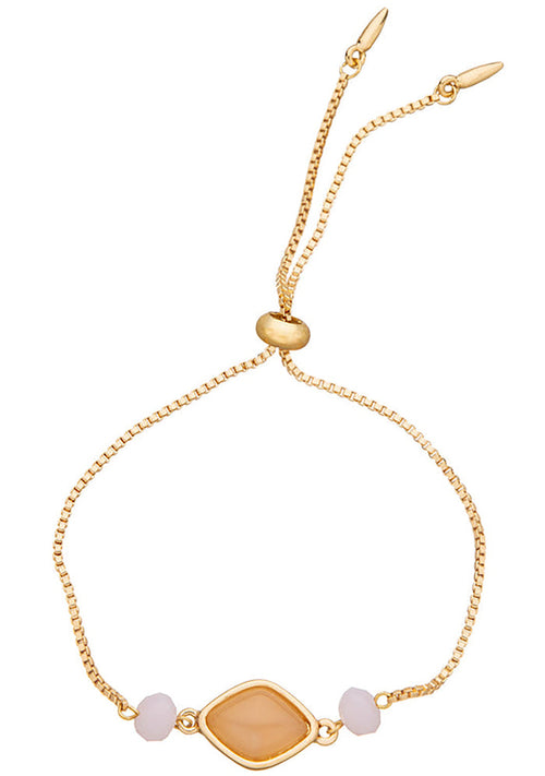 Charged Heart Rose Quartz Gemstone Bracelet in gold with raw rose quartz centerpiece and glass bead accents on adjustable 18k gold plated crystal festival bracelet — front view
