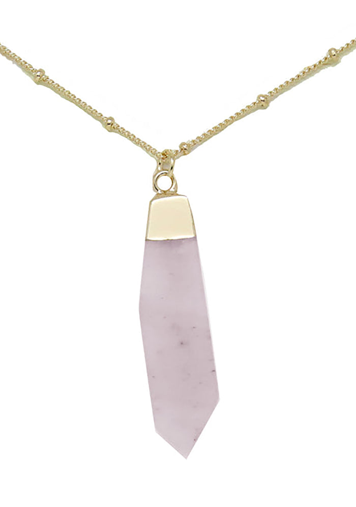 Charged Heart Rose Quartz Gemstone Necklace in gold with raw soft pink rose quartz stone pendant on 18k gold plated chain crystal festival necklace — front view