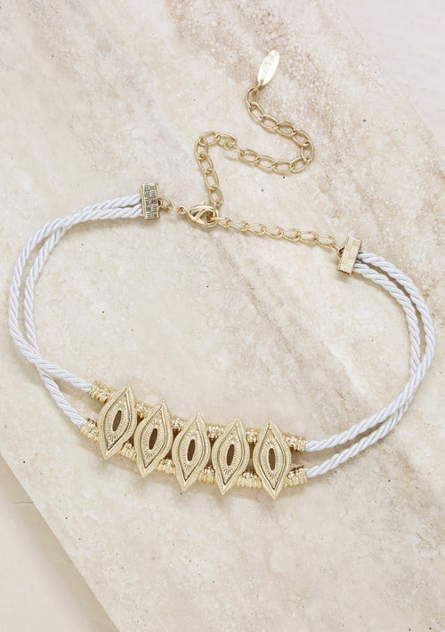 Ettika Industrial Choker in cream gold with double-roped cord and etched centerpiece detail on festival necklace — model view