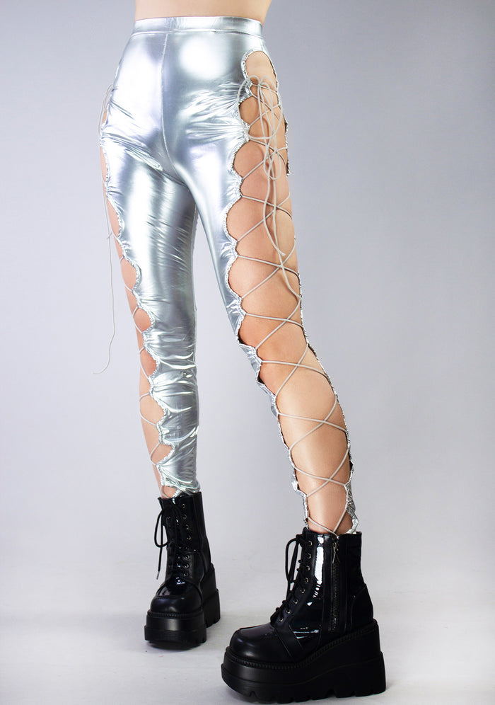 Hot & Delicious Intergalactic Metallic Lace Up Leggings in silver with cut-out lace-up side detail on rave bottoms — model view