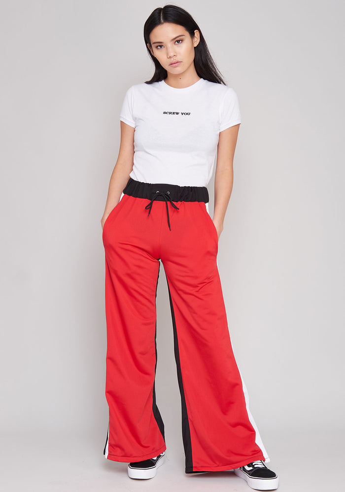 The Ragged Priest Jux Jogger Pants in red multi — model side view