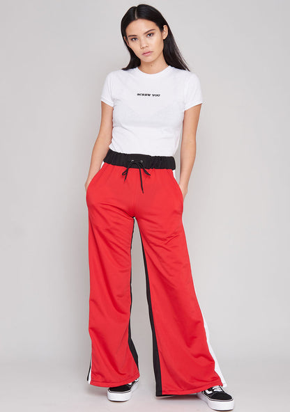 The Ragged Priest Jux Jogger Pants in red multi — model side view