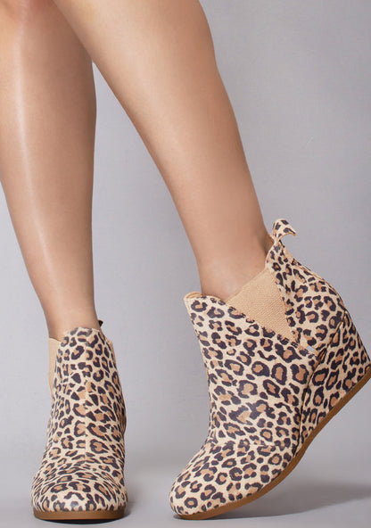 TOMS Kelsey Suede Boot in leopard with all-over leopard print on suede wedge heel festival ankle boot — model front view