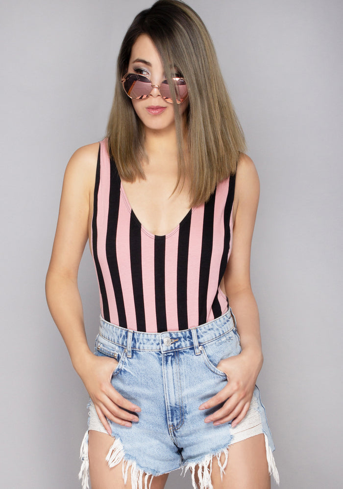 Motel Rocks Lalung Lycra Stripe Bodysuit in pink black with stripe graphic and thick straps on rave bodysuit — model view