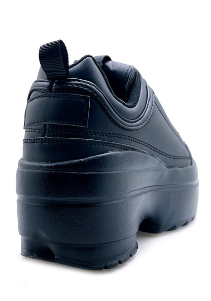 Rear view of the black Berness platform sneakers, detailing the high-profile chunky rubber heel and clean stitched seams.