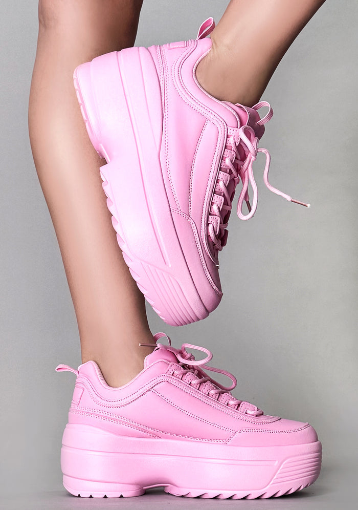 Side angle on-foot shot of the Berness LILY 5005 Sugar Pop pink platform rave sneakers, highlighting the low-top silhouette, 2-inch platform height, and clean tone-on-tone pink stitching.