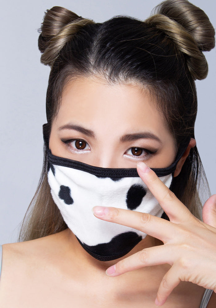 BGlittz Moo Moo Dust Mask in black white with all-over cow print on breathable nylon rave festival face mask — model view