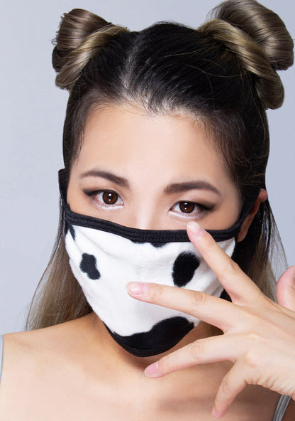 BGlittz Moo Moo Dust Mask in black white with all-over cow print on breathable nylon rave festival face mask — model view