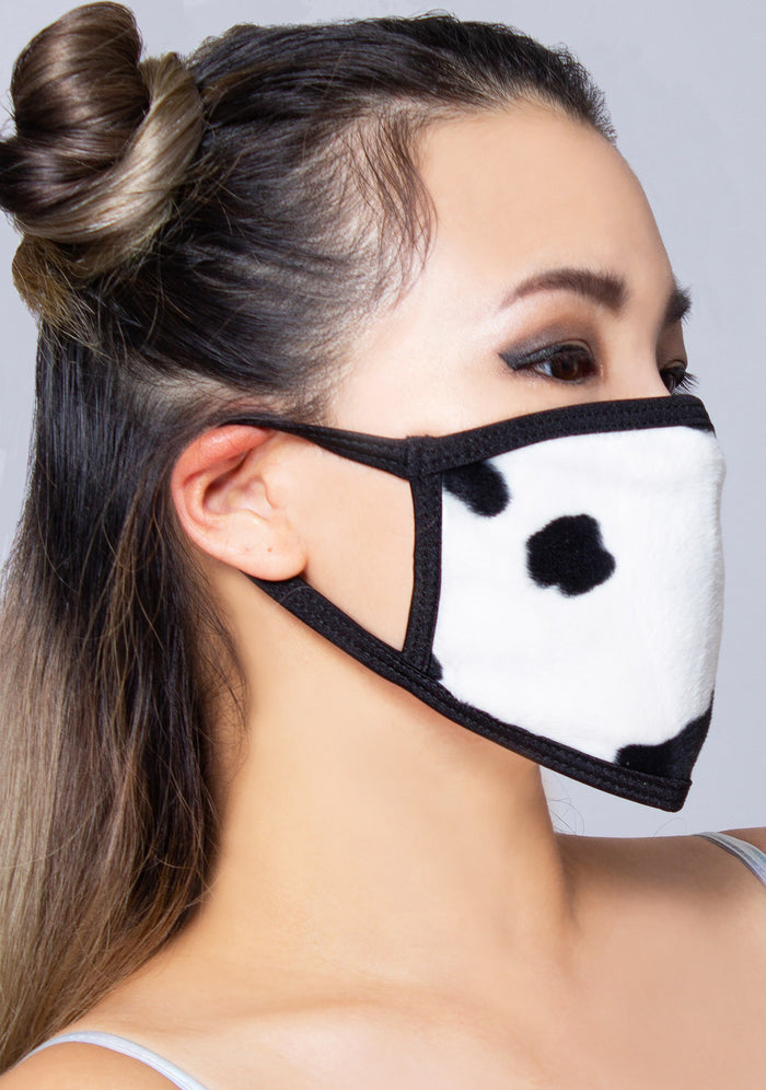 BGlittz Moo Moo Dust Mask in black white with all-over cow print on breathable nylon rave festival face mask — model side view