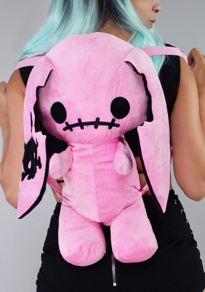 Sleepyville Critters Naughty Bunny Pink Plush Backpack in pink with 3D bunny plush design and skull patch ear accent on kawaii goth rave backpack — model back view