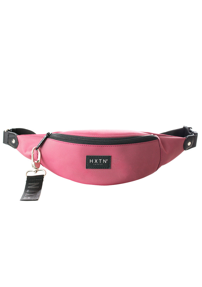 HXTN Supply Prime One Belt Bag in burgundy with zip-protected body and logo patch on festival rave belt bag — front view