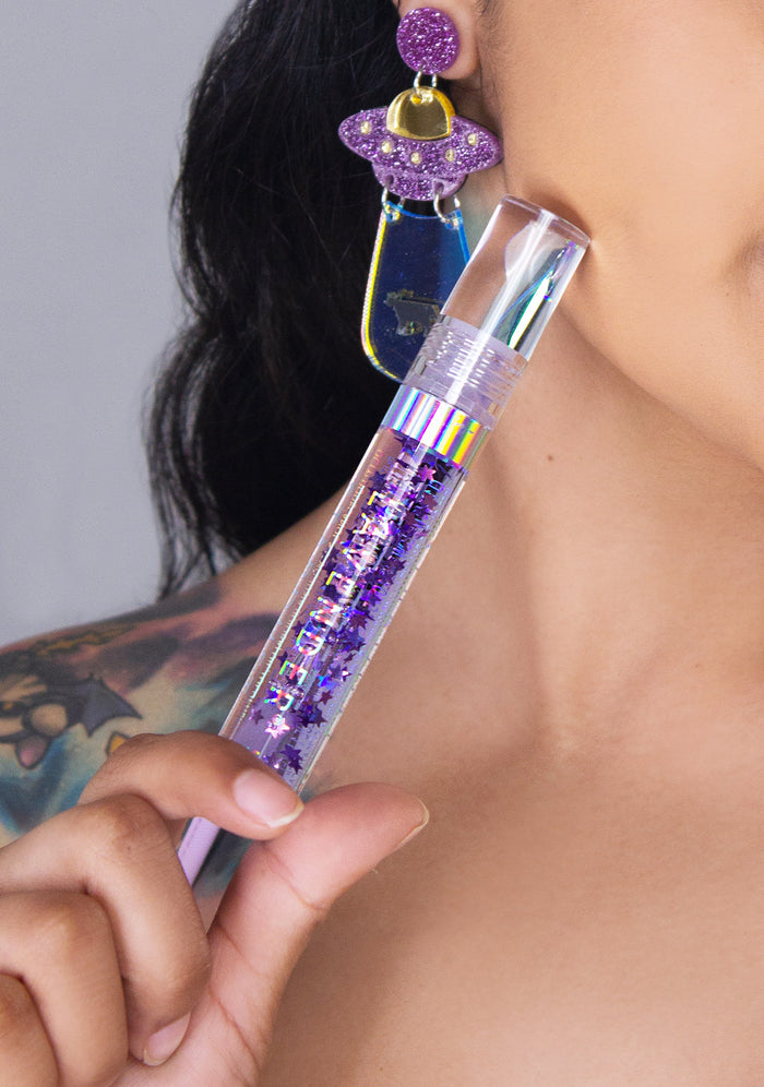 Lavender Stardust Purple Rain Cosmic Lip Gloss in purple — model view