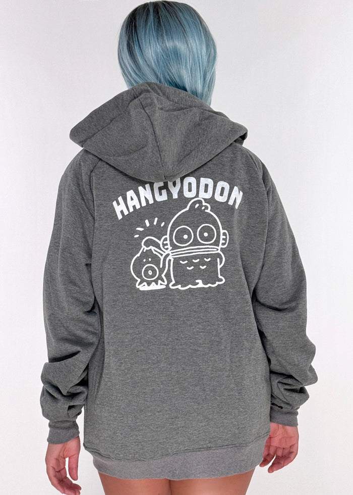 Sanrio Hangyodon Sherpa Zip Up Hoodie in charcoal with Hangyodon embroidery on sherpa-lined zip-up rave festival jacket — model back view