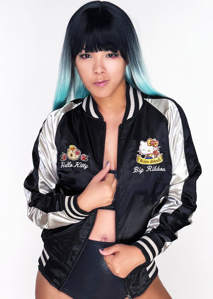 Sanrio Hello Kitty Rose Tattoo Bomber Jacket in black gold with Hello Kitty embroidery and rose tattoo design on satin fabric — model front view