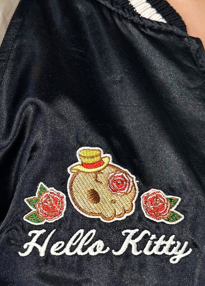 Sanrio Hello Kitty Rose Tattoo Bomber Jacket in black gold with Hello Kitty embroidery and rose tattoo design on satin fabric — embroidery detail view