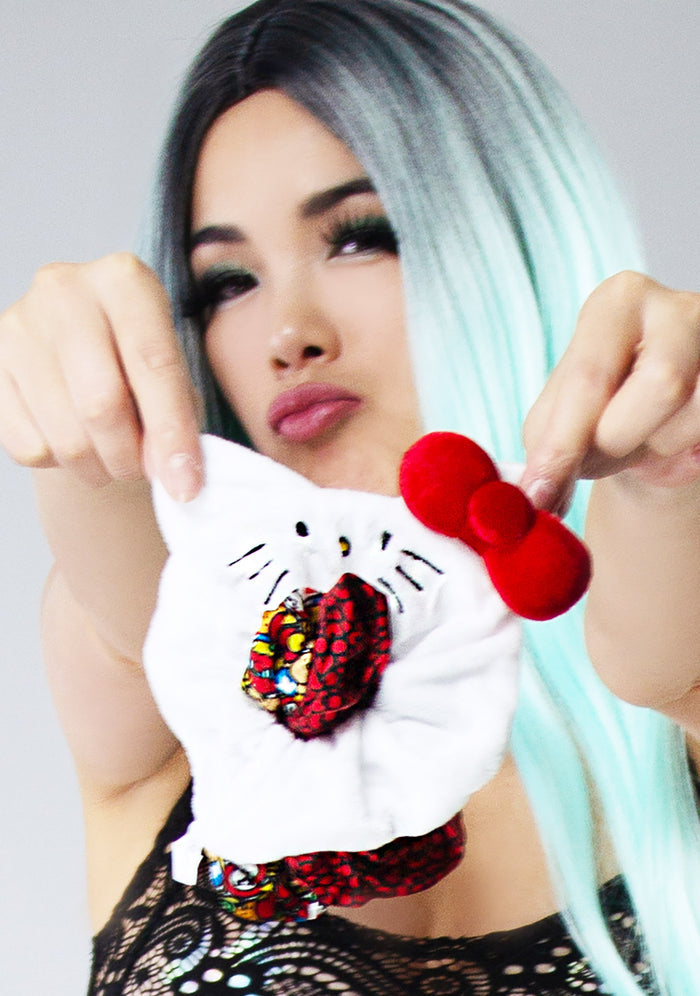 Bioworld Sanrio Hello Kitty Scrunchies 3 Pack Set in multicolor with 2 satin AOP scrunchies and 1 plush Hello Kitty face scrunchie on kawaii rave hair accessories — model view