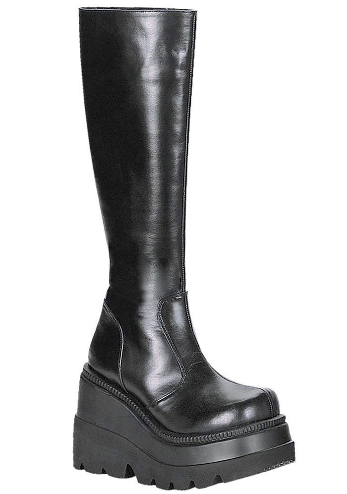 Demonia SHAKER 100 Total Blackout Black Platform Boots in black vegan PU leather with 4.5 inch stacked wedge platform and clean minimal design — front view