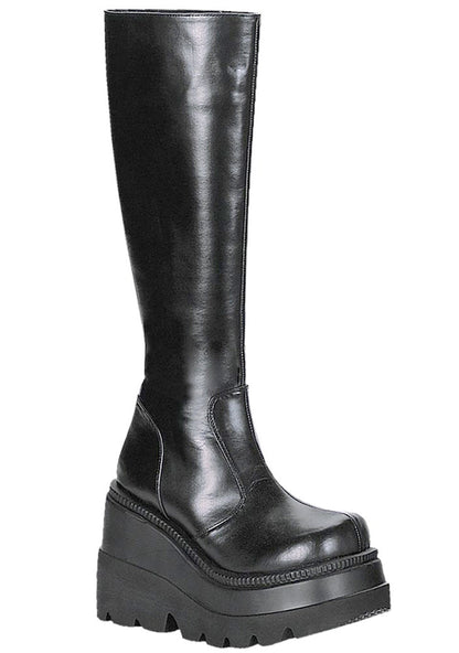 Demonia SHAKER 100 Total Blackout Black Platform Boots in black vegan PU leather with 4.5 inch stacked wedge platform and clean minimal design — front view