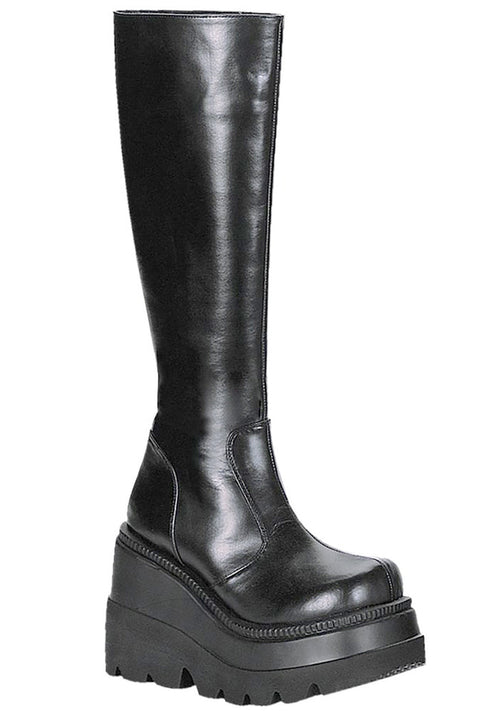 Demonia SHAKER 100 Total Blackout Black Platform Boots in black vegan PU leather with 4.5 inch stacked wedge platform and clean minimal design — front view