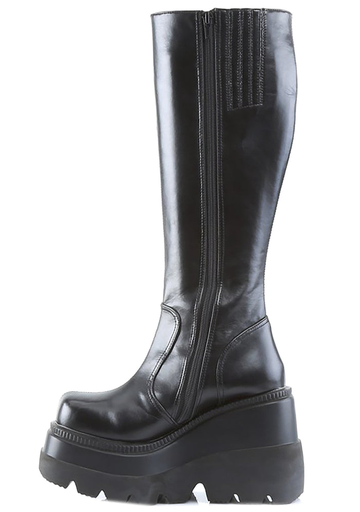 Demonia SHAKER 100 Total Blackout Black Platform Boots in black vegan PU leather showing interior zipper closure and platform sole detail — detail shot