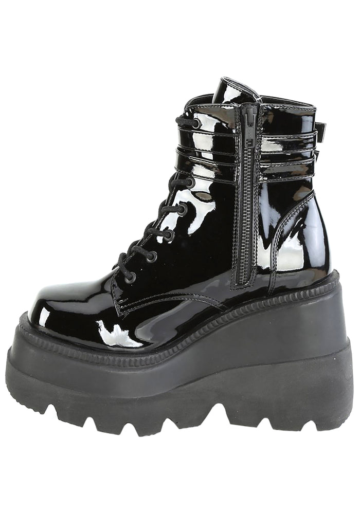 Demonia SHAKER 52 Paint it Black Patent Black Platform Boots in black patent leather showing double buckle ankle strap and lace-up front detail — detail shot