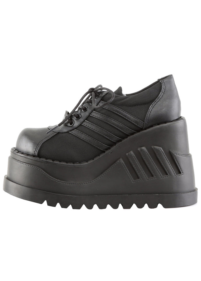 Demonia STOMP 08 Black Rave Platform Sneakers in black vegan leather showing sporty stripe detail and lace-up front closure — detail shot
