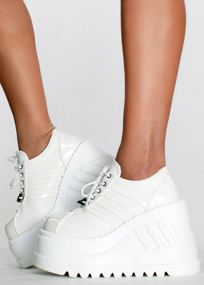 Demonia STOMP 08 White Rave Platform Sneakers in white vegan leather with lace-up closure and chunky rubber platform worn by model — side view