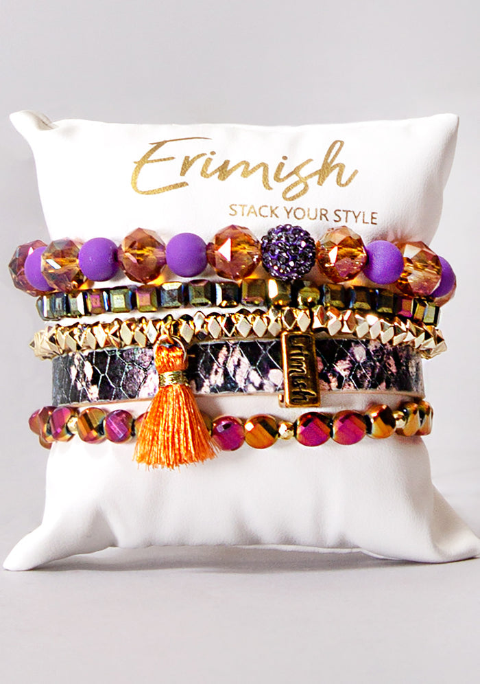 Erimish Sunset Sky Bracelet Stack in orange purple gold with vegan snakeskin band and tassel charm on festival bracelet stack — front model view