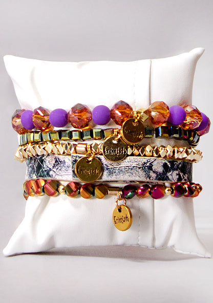 Erimish Sunset Sky Bracelet Stack in orange purple gold with vegan snakeskin band and tassel charm on festival bracelet stack — back model view