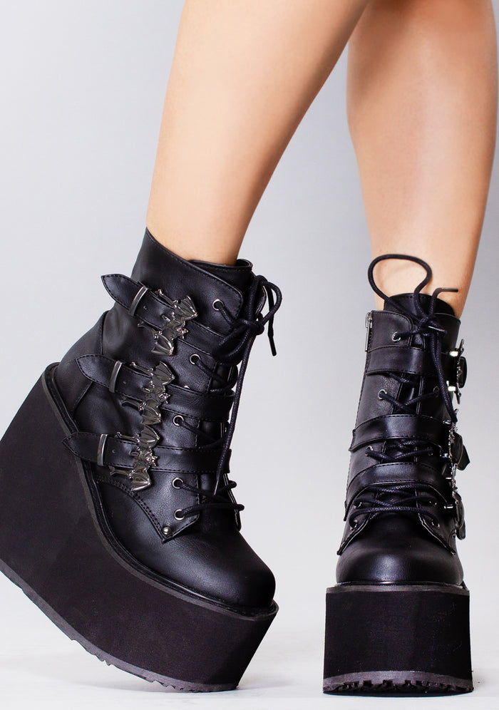 Demonia SWING 103 Creature of the Night Black Platform Boots in black vegan leather with 5.5 inch wedge platform and triple buckle straps worn by model — front view