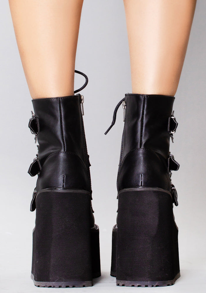 Demonia SWING 103 Creature of the Night Black Platform Boots in black vegan leather with metal zip closure worn by model — back view